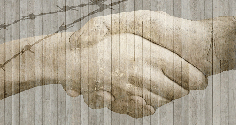 Hände Handschlag Grenze mit Zaun